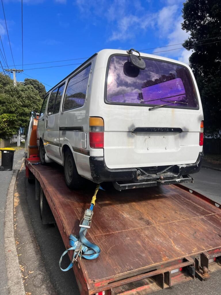 broken van secured on tow truck in porirua after being sold for cash